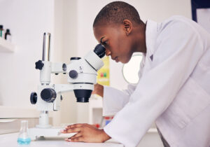 Senior, scientist and black woman, microscope and analysis of data, medical research and science study in lab. Future, knowledge and investigation, female doctor and check DNA sample with chemistry.